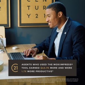 A real estate agent working on a laptop with CENTURY 21 branding in the background, highlighting the productivity benefits of using the MoxiImpress tool.