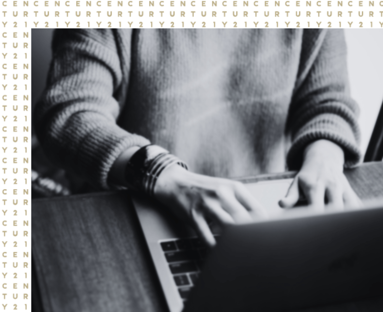 Close-up of a real estate agent working on a laptop at CENTURY 21 Triangle Group office, focused on the screen.