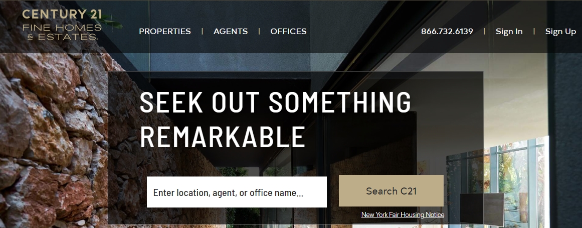 Century 21 Fine Homes & Estates website homepage with a search bar overlaying an image of a modern home with large glass windows and a stone wall.